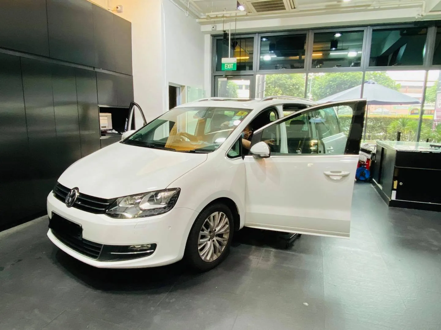 Side view of a white Volkswagen Sharan with door open at Infratint Singapore