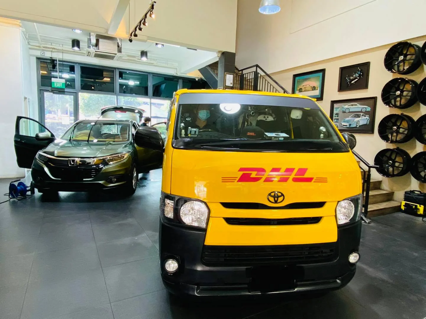 Yellow DHL Toyota Hiace delivery van and a green Honda SUV inside Infratint Singapore