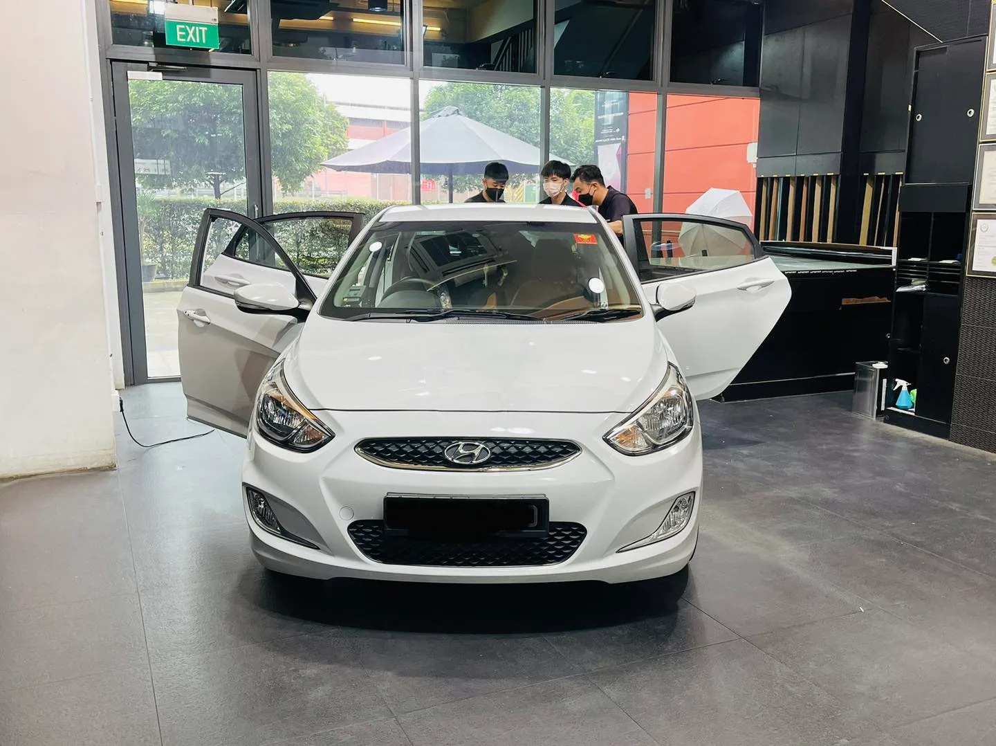 White Hyundai Accent getting window tinting at the Infratint Singapore showroom