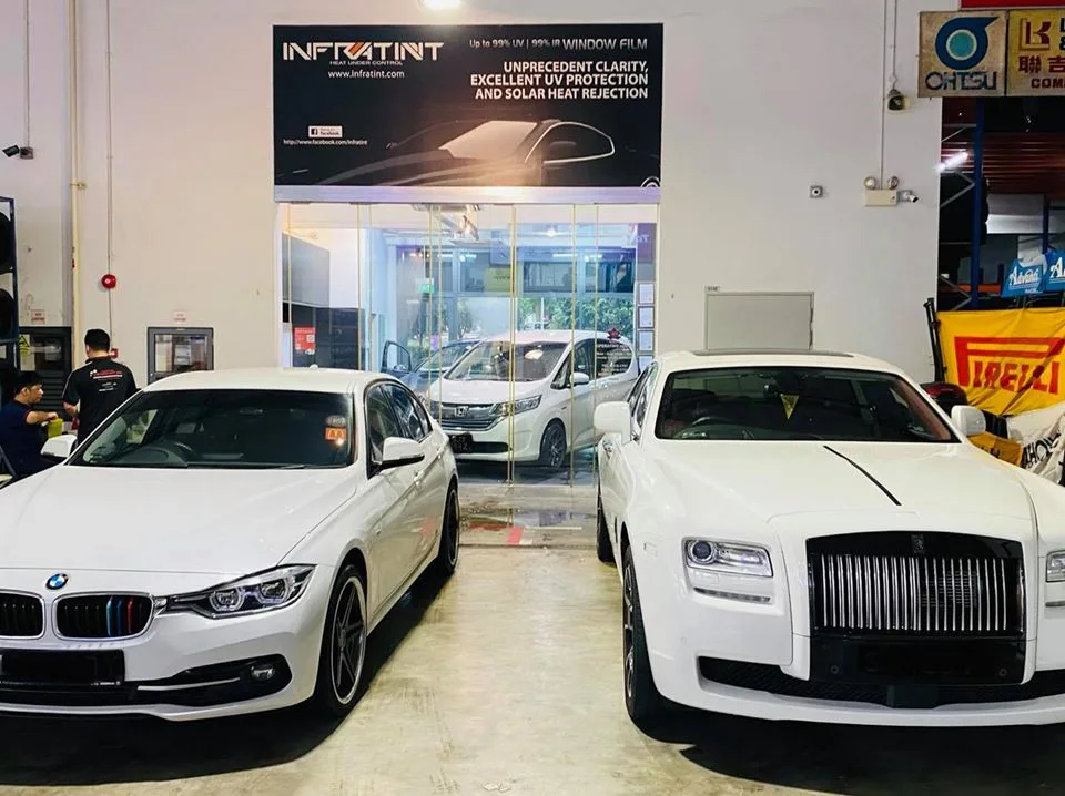 White BMW 3 Series and white Rolls-Royce at Infratint Singapore for window tinting