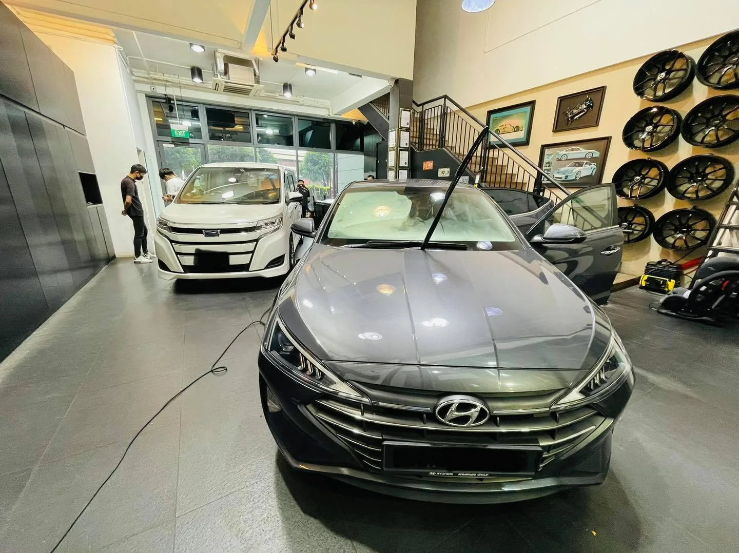 Grey Hyundai Avante sedan and white Toyota MPV at Infratint Singapore