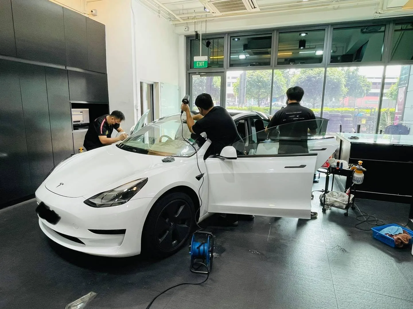 White Tesla Model 3 having its windows tinted at Infratint Singapore