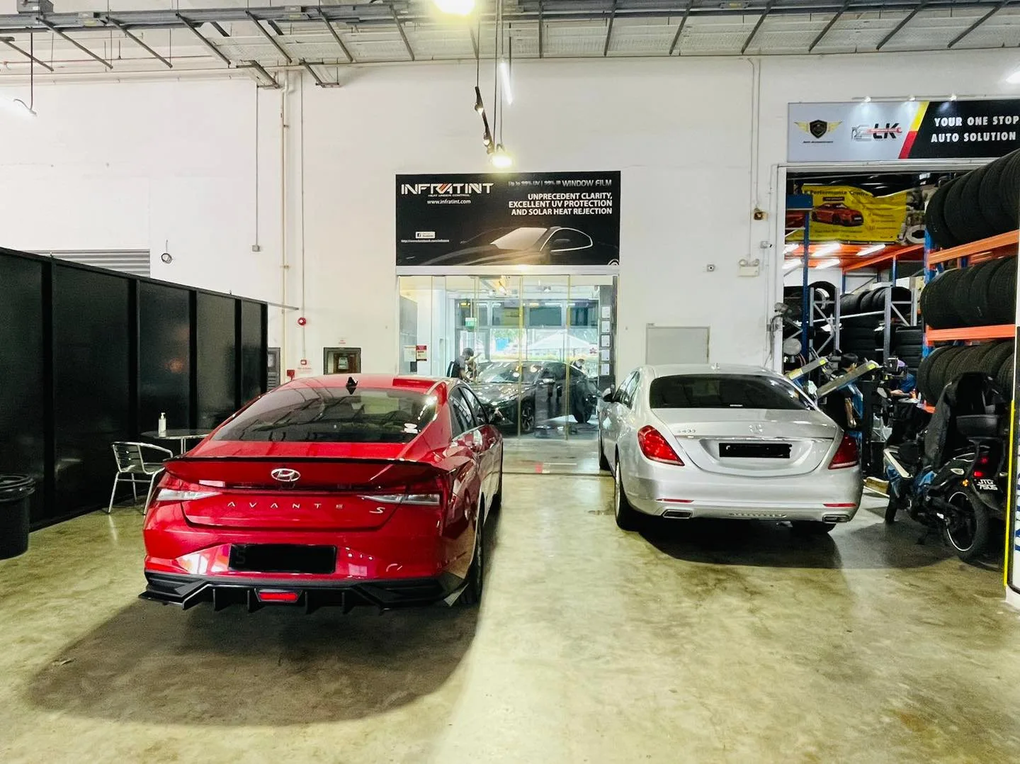 Red Hyundai sedan and silver Mercedes-Benz S-Class inside Infratint Singapore