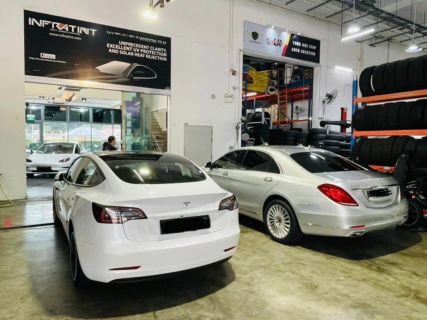 White Tesla Model 3 and silver Mercedes-Benz S-Class inside Infratint Singapore