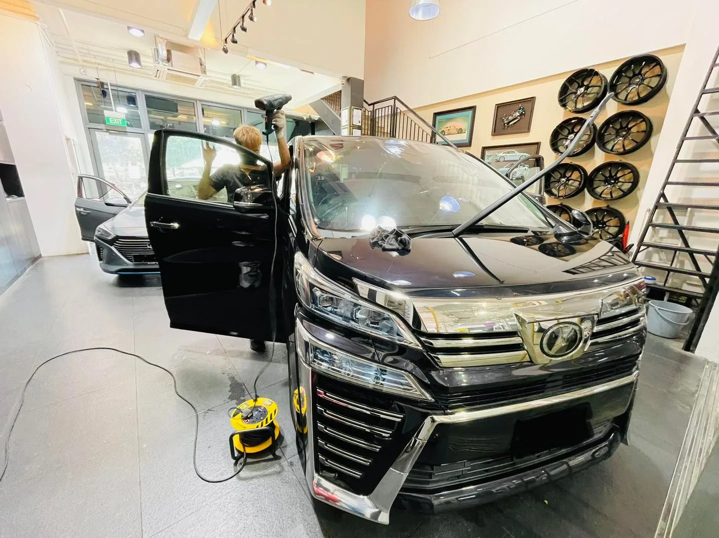 Black Toyota Vellfire MPV being prepared for window film at Infratint Singapore