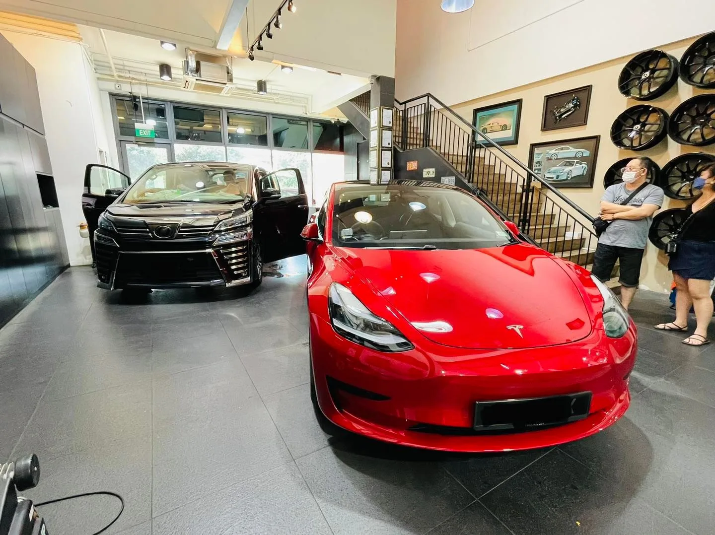 Red Tesla Model 3 and black Toyota Vellfire inside the Infratint Singapore showroom