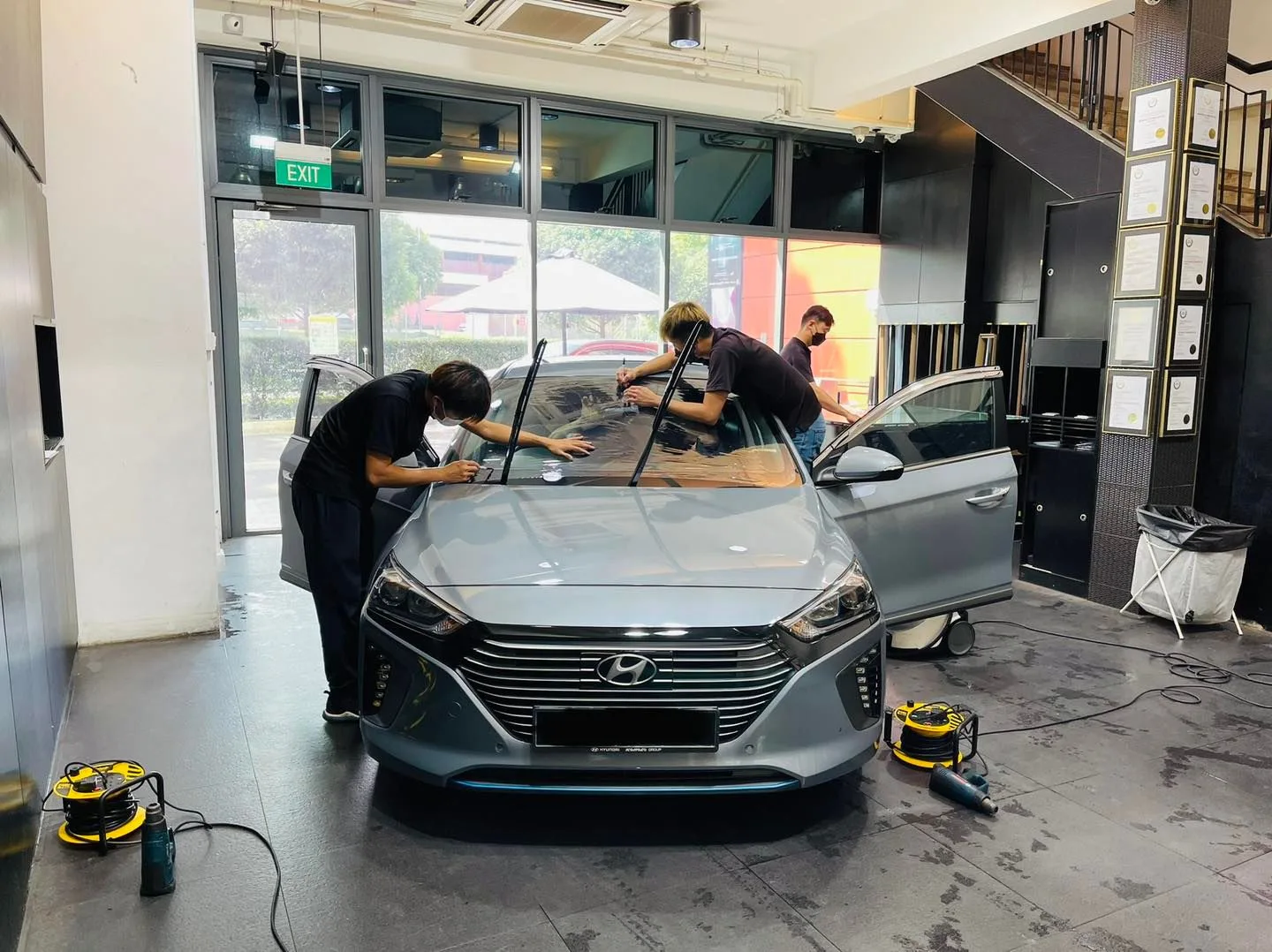 Silver Hyundai Ioniq front view during window tinting at Infratint Singapore