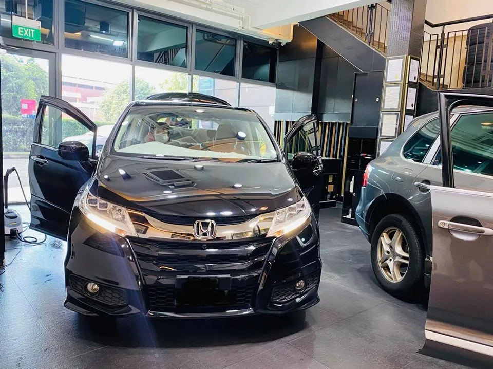 Black Honda Odyssey MPV with doors open at Infratint Singapore