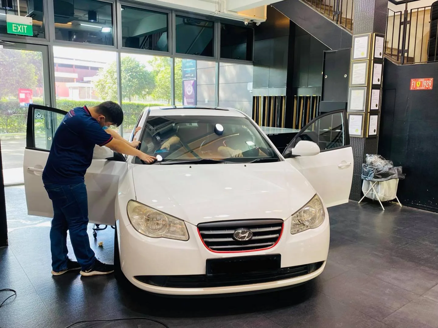 White Hyundai Avante sedan getting window film at Infratint Singapore