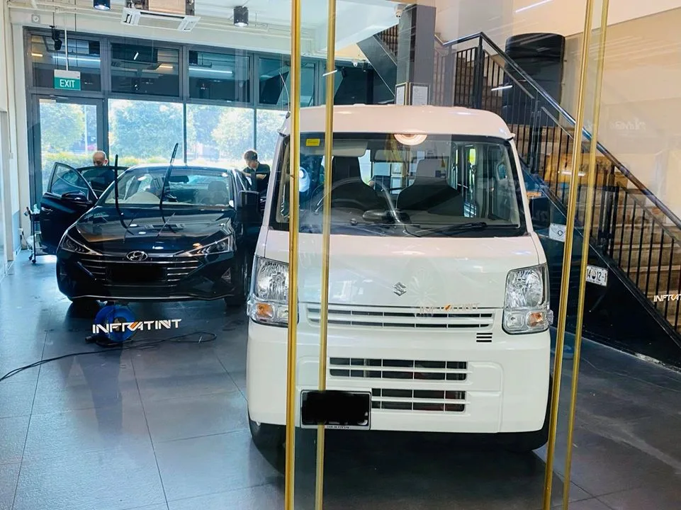 White Suzuki Every van and dark blue Hyundai inside Infratint Singapore