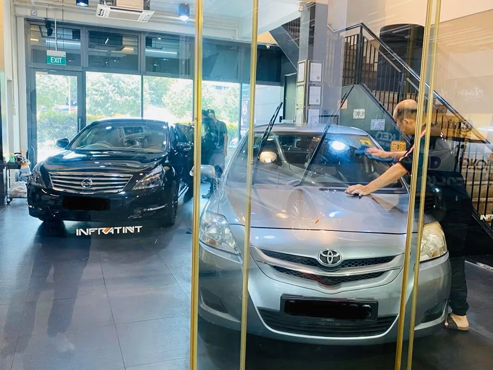 Silver Toyota Vios being wiped down with a Nissan Teana behind at Infratint Singapore