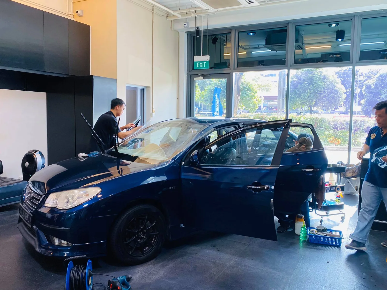 Blue Hyundai Avante with door open during window tinting at Infratint Singapore
