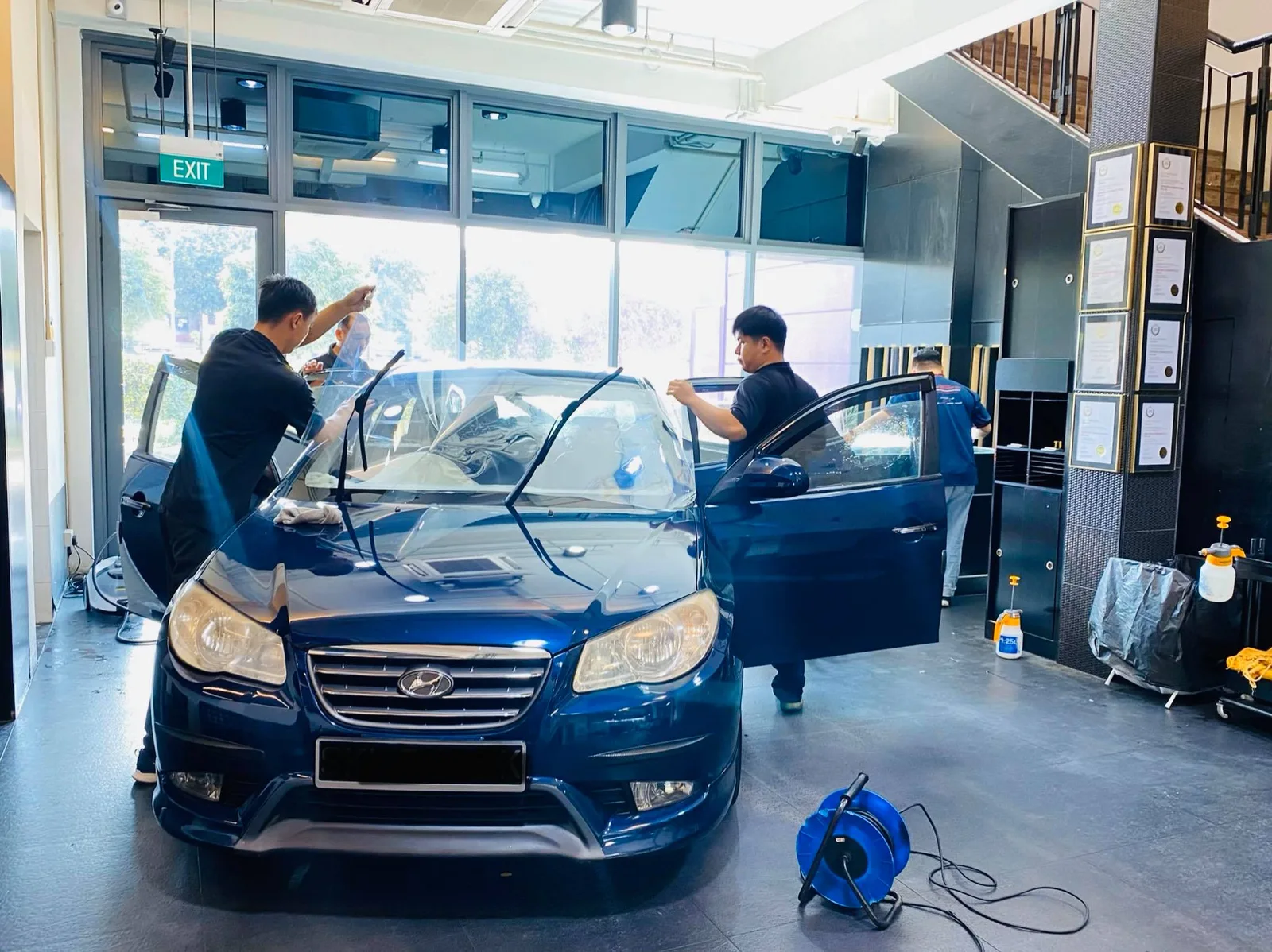 Dark blue Hyundai Avante sedan getting window film prepped at Infratint Singapore
