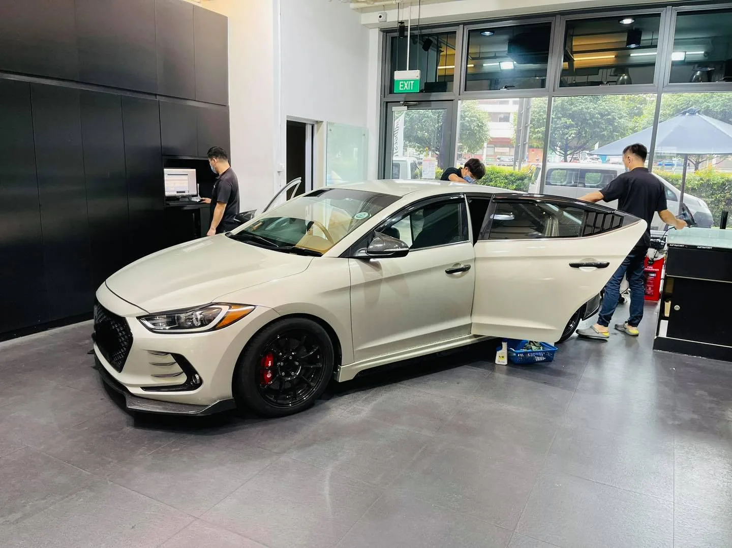 Champagne Hyundai Elantra side view during window film installation at Infratint Singapore