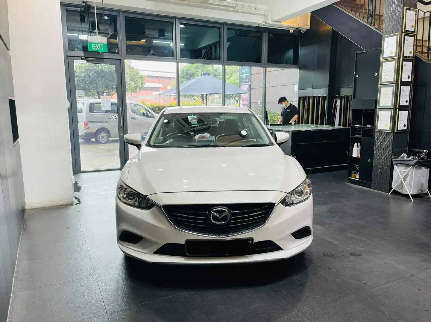White Mazda sedan front view at Infratint Singapore for window tinting