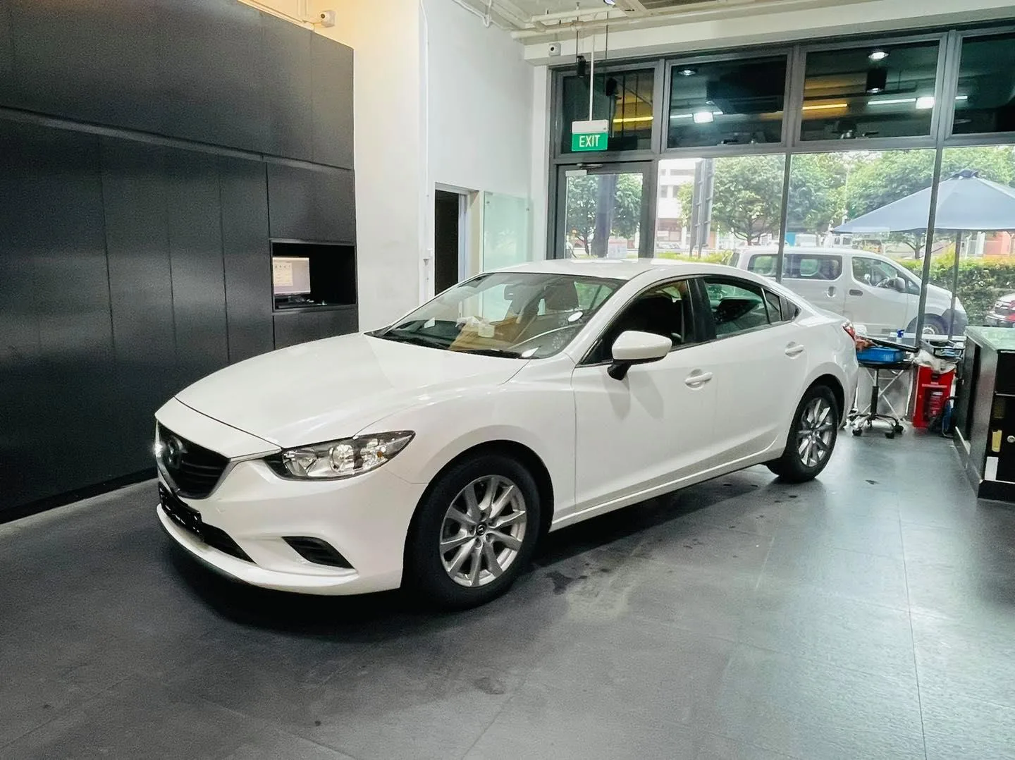 White Mazda sedan front three-quarter view at Infratint Singapore window tinting