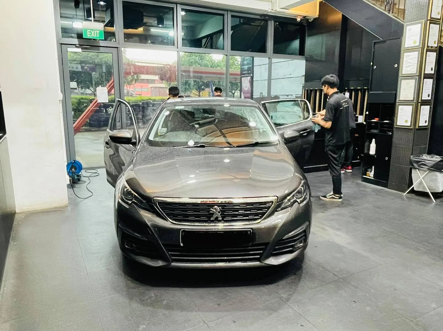 Front of a grey Peugeot sedan in the showroom at Infratint Singapore