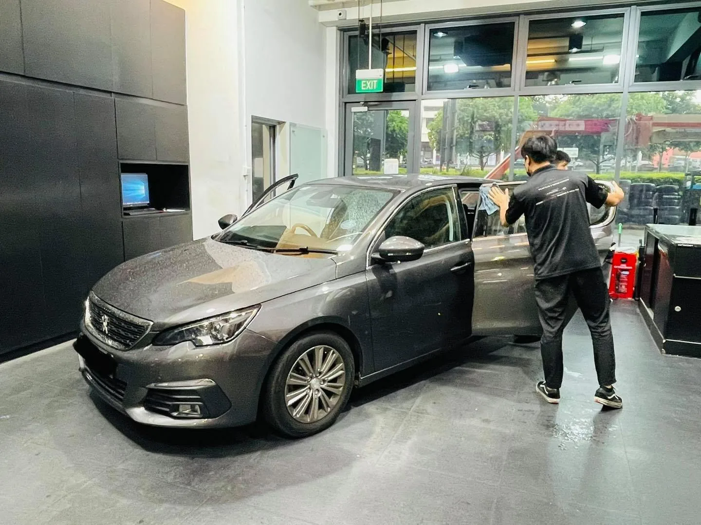 Grey Peugeot side glass being tinted with the door open at Infratint Singapore