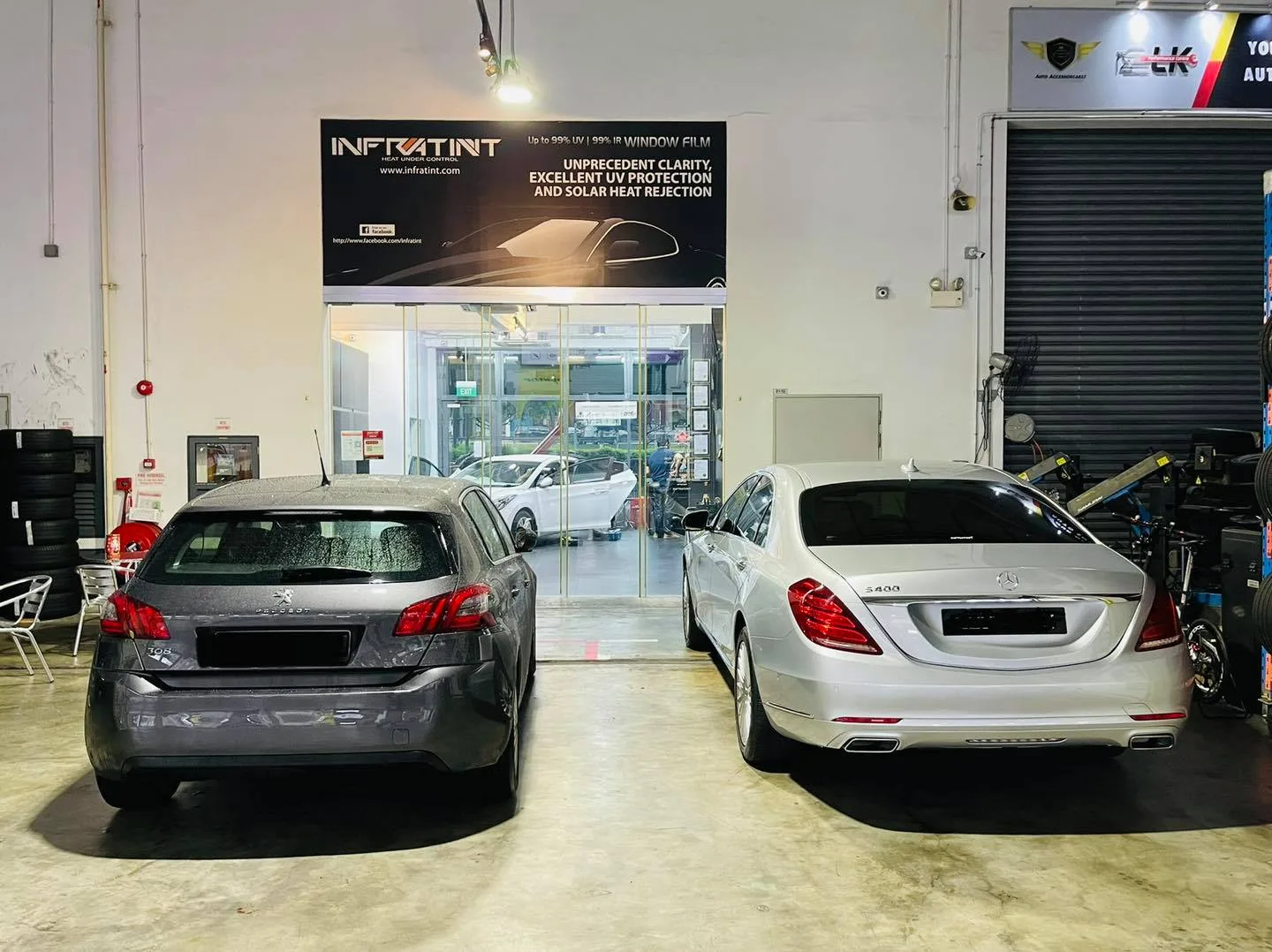 Grey Peugeot and silver Mercedes-Benz sedan in the install bay at Infratint Singapore