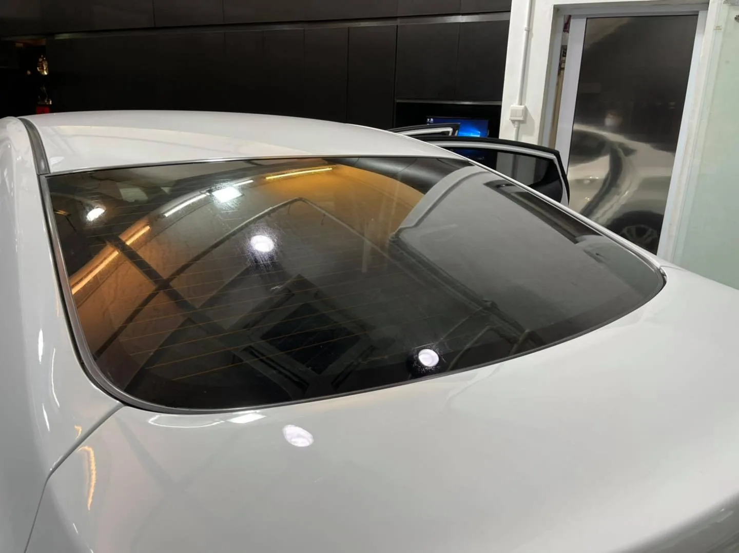 Tinted rear windscreen on a white sedan showing crisp film application at Infratint Singapore
