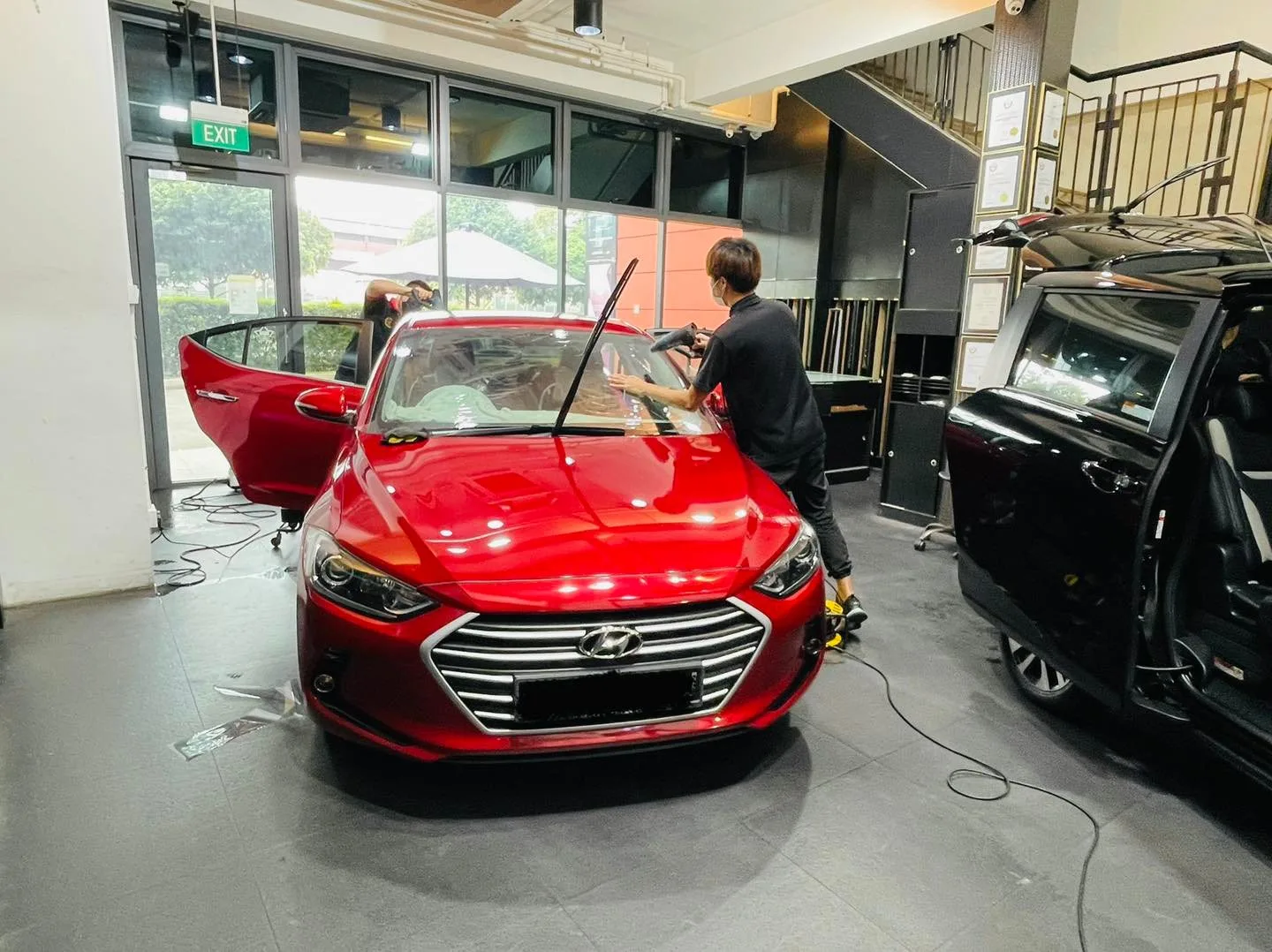 Red Hyundai Elantra getting windscreen film fitted at Infratint Singapore
