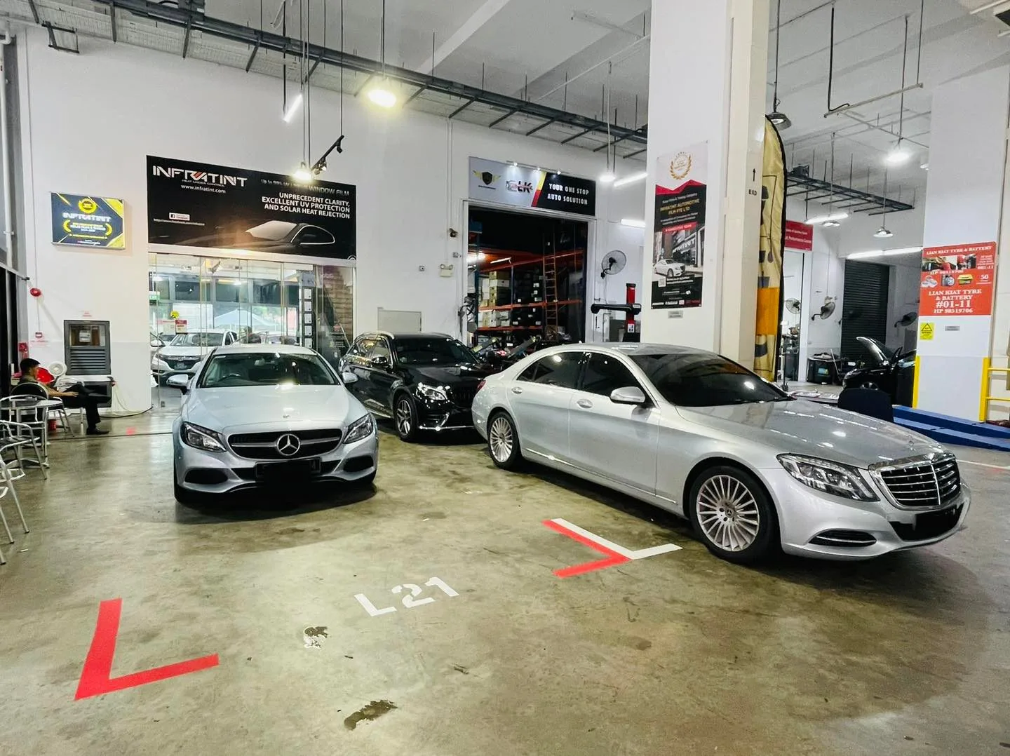 Silver Mercedes-Benz C-Class and S-Class parked in the install bays at Infratint Singapore