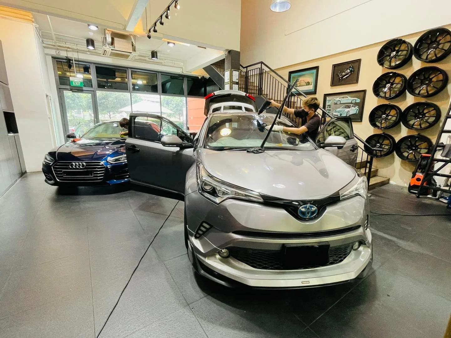 Grey Toyota C-HR and blue Audi inside the Infratint Singapore showroom