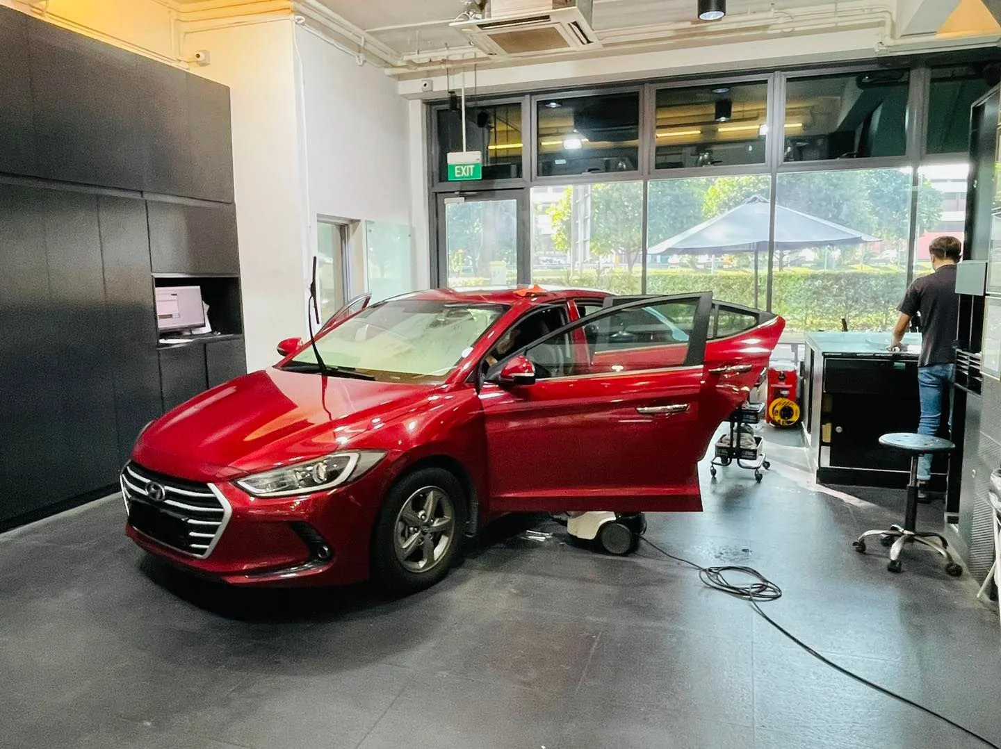 Red Hyundai Elantra being prepared for window film at Infratint Singapore