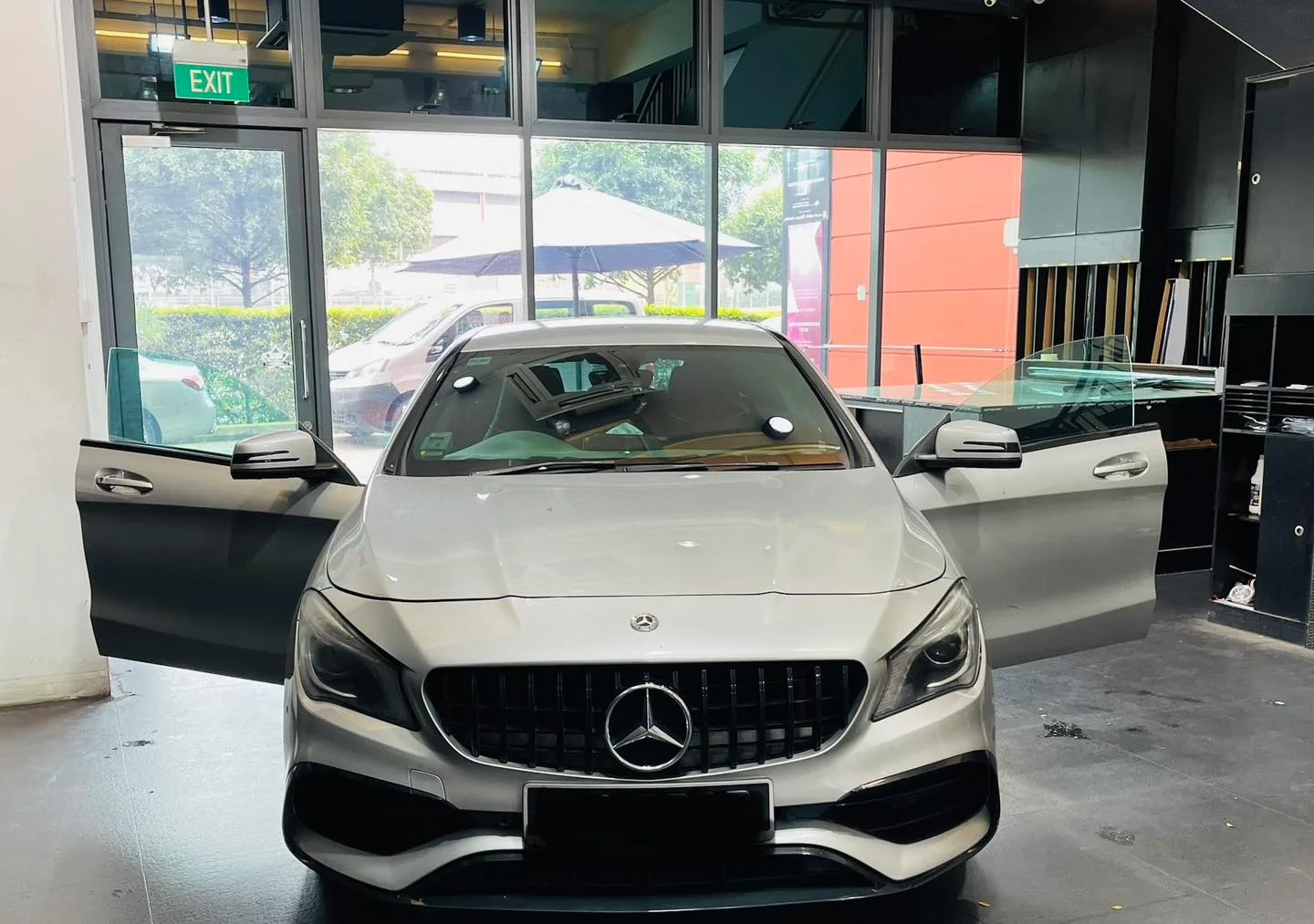Silver Mercedes-Benz CLA with doors open during window tinting at Infratint Singapore
