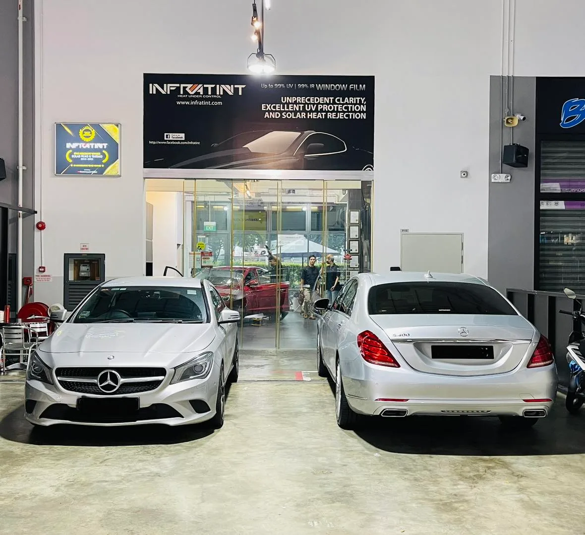 Silver Mercedes-Benz CLA and S-Class beneath the Infratint Singapore banner