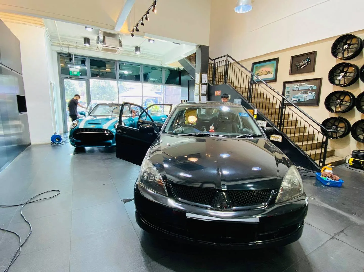 Black Mitsubishi sedan inside the Infratint Singapore showroom for window tinting