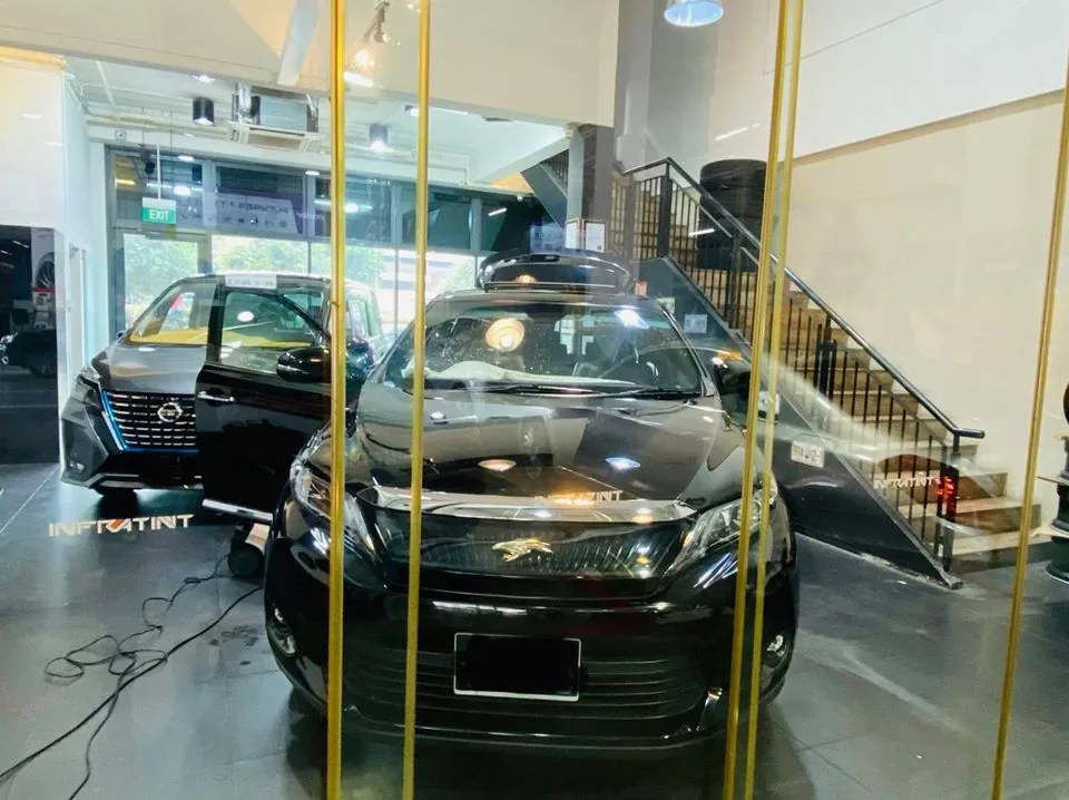 Black Toyota Harrier seen through the glass entrance at Infratint Singapore