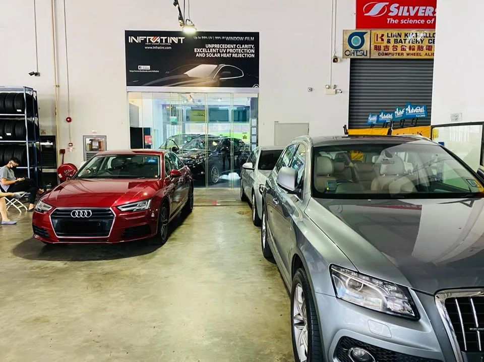 Red Audi A4 and silver Audi SUV lined up for window tinting at Infratint Singapore