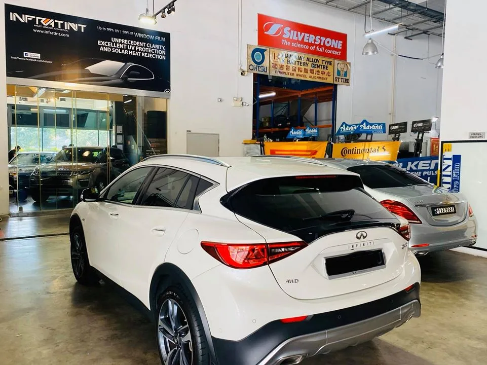 White Infiniti Q30 rear three-quarter at Infratint Singapore for window tinting