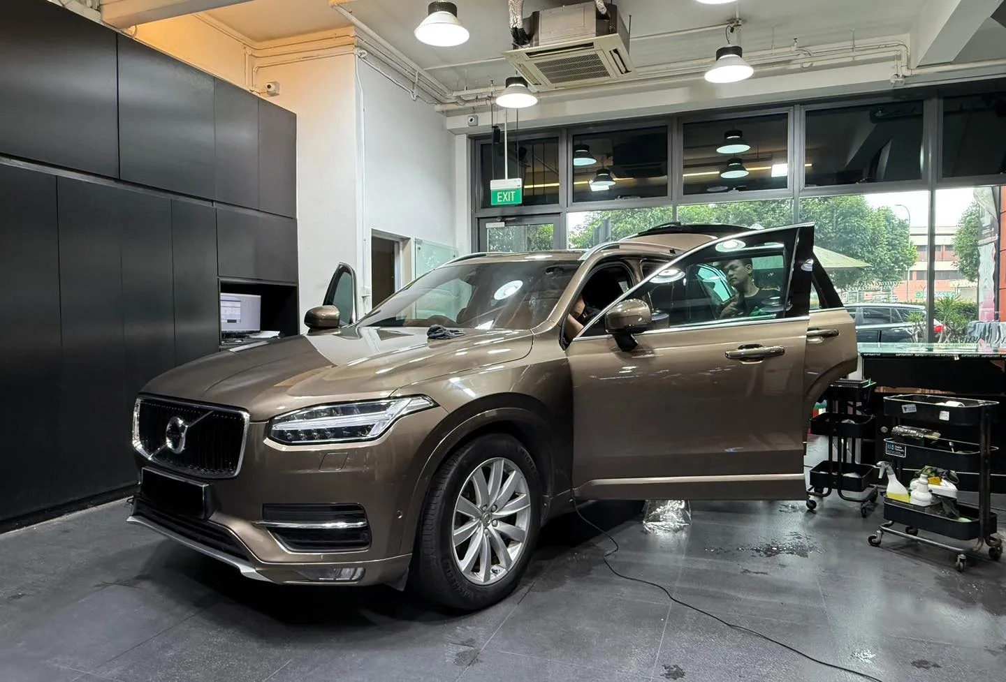 Infratint installer fitting window film to a Volvo XC90 in the workshop
