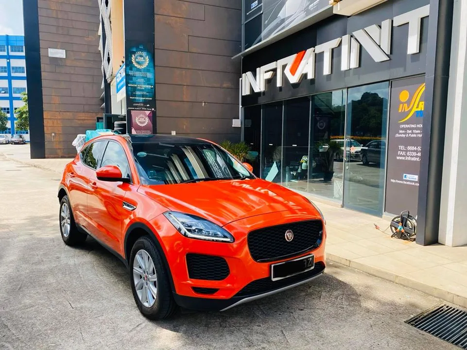 Orange Jaguar E-PACE outside the Infratint Singapore shopfront after window tinting