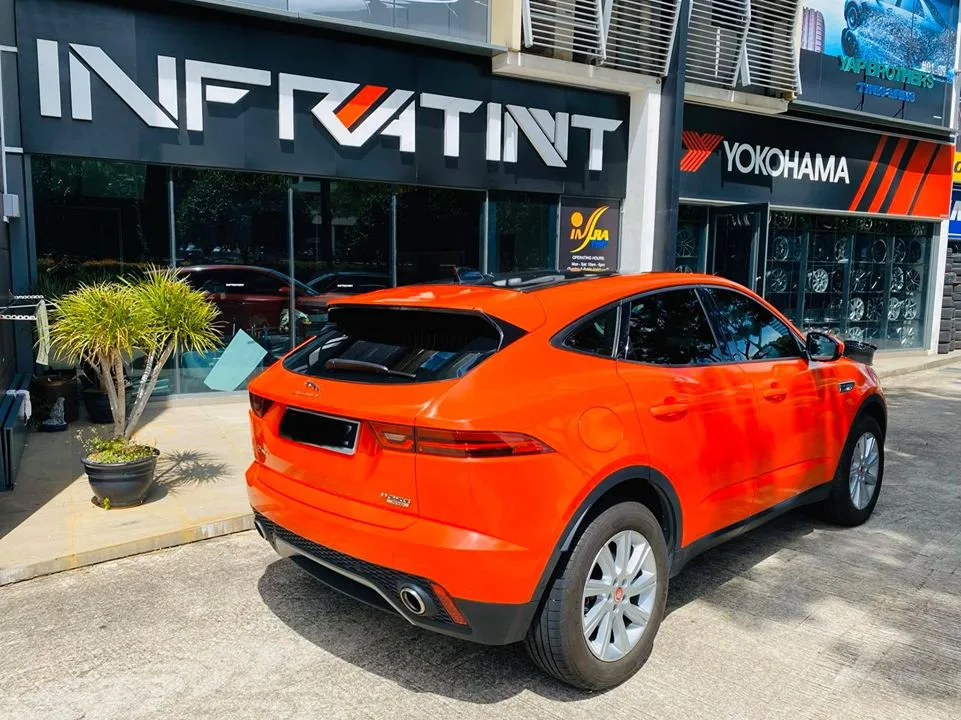 Orange Jaguar E-PACE leaving the Infratint Singapore shopfront after window tinting
