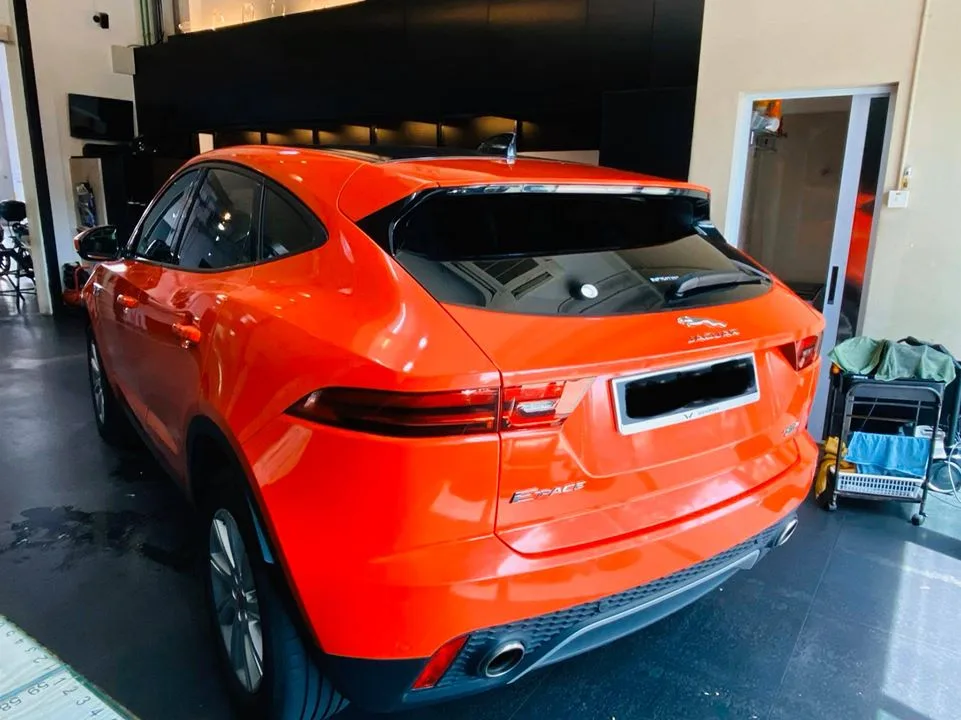 Rear of an orange Jaguar E-PACE with tinted tailgate glass at Infratint Singapore