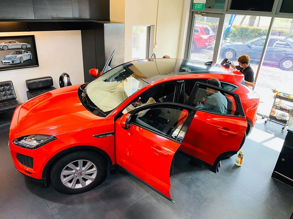 Orange Jaguar E-PACE having its windows tinted at Infratint Singapore