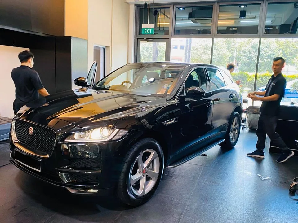 Black Jaguar F-Pace front three-quarter view during window tinting at Infratint Singapore