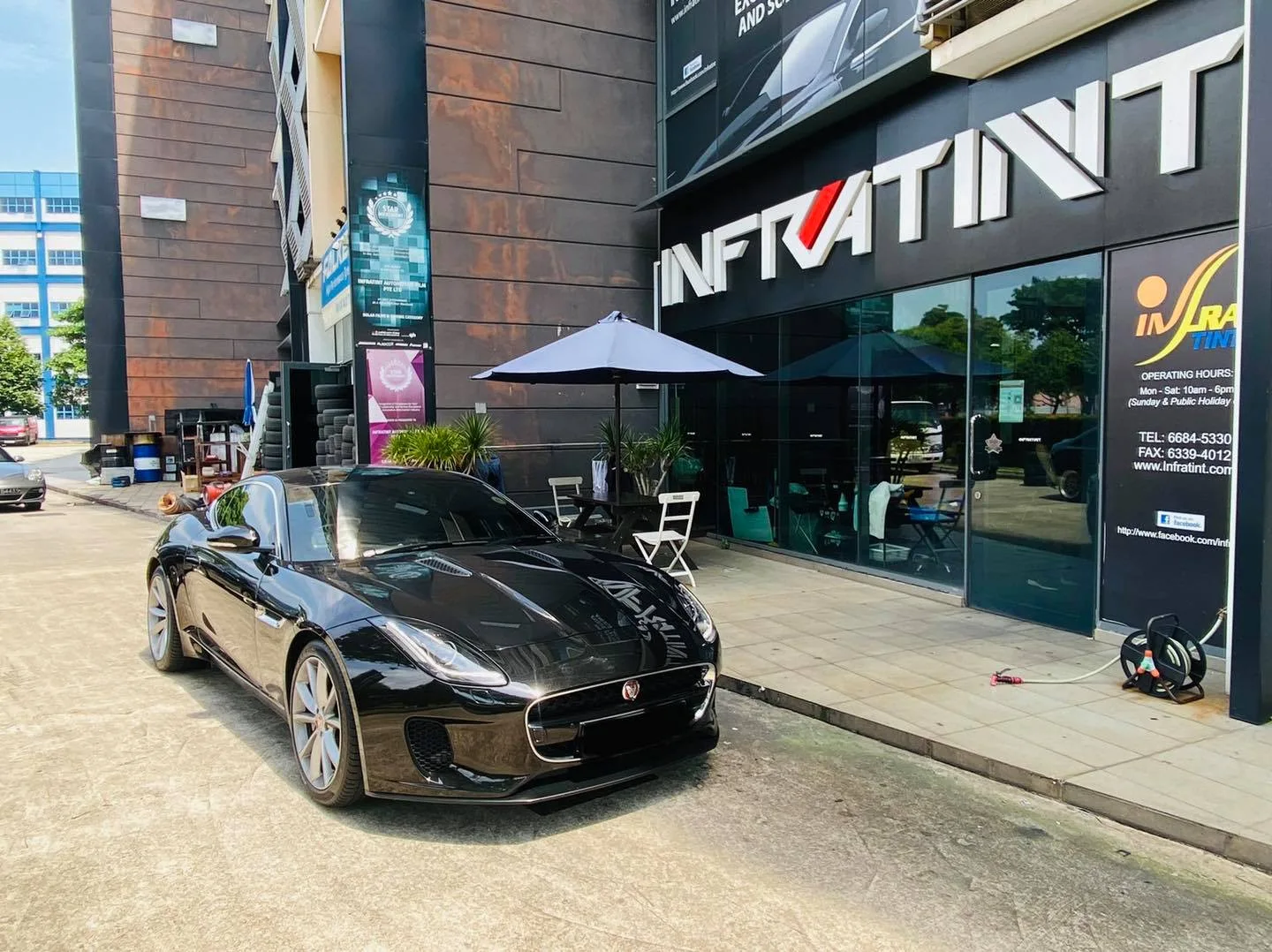 Black Jaguar F-Type coupe outside the Infratint Singapore shopfront