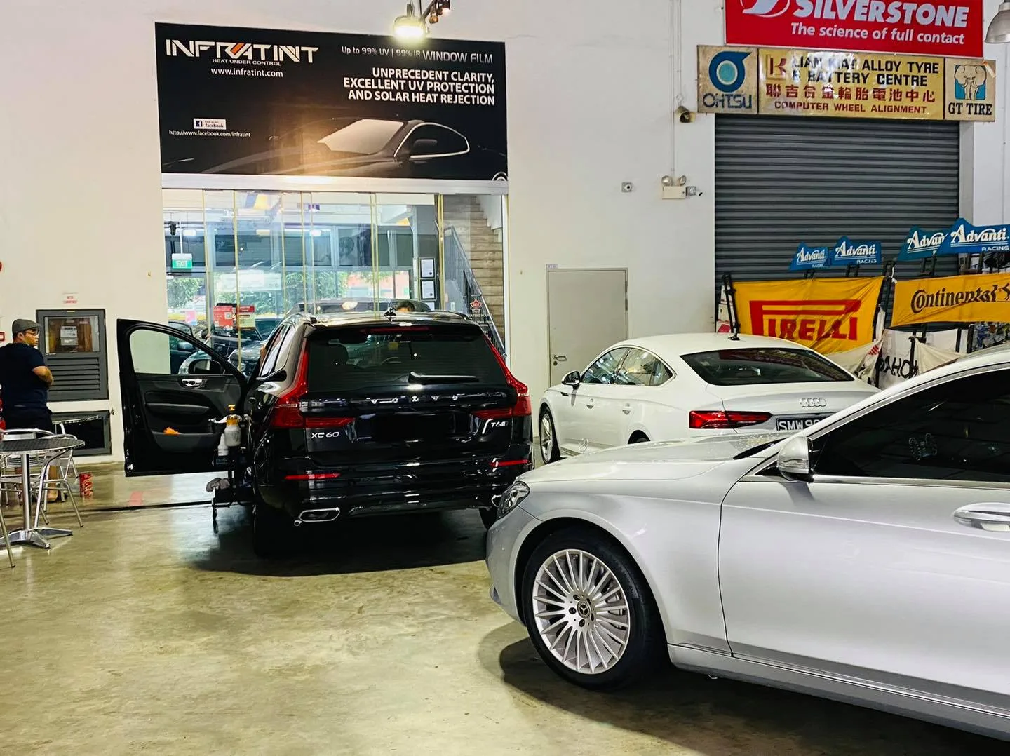 Black Volvo wagon and silver Mercedes-Benz at Infratint Singapore for window film