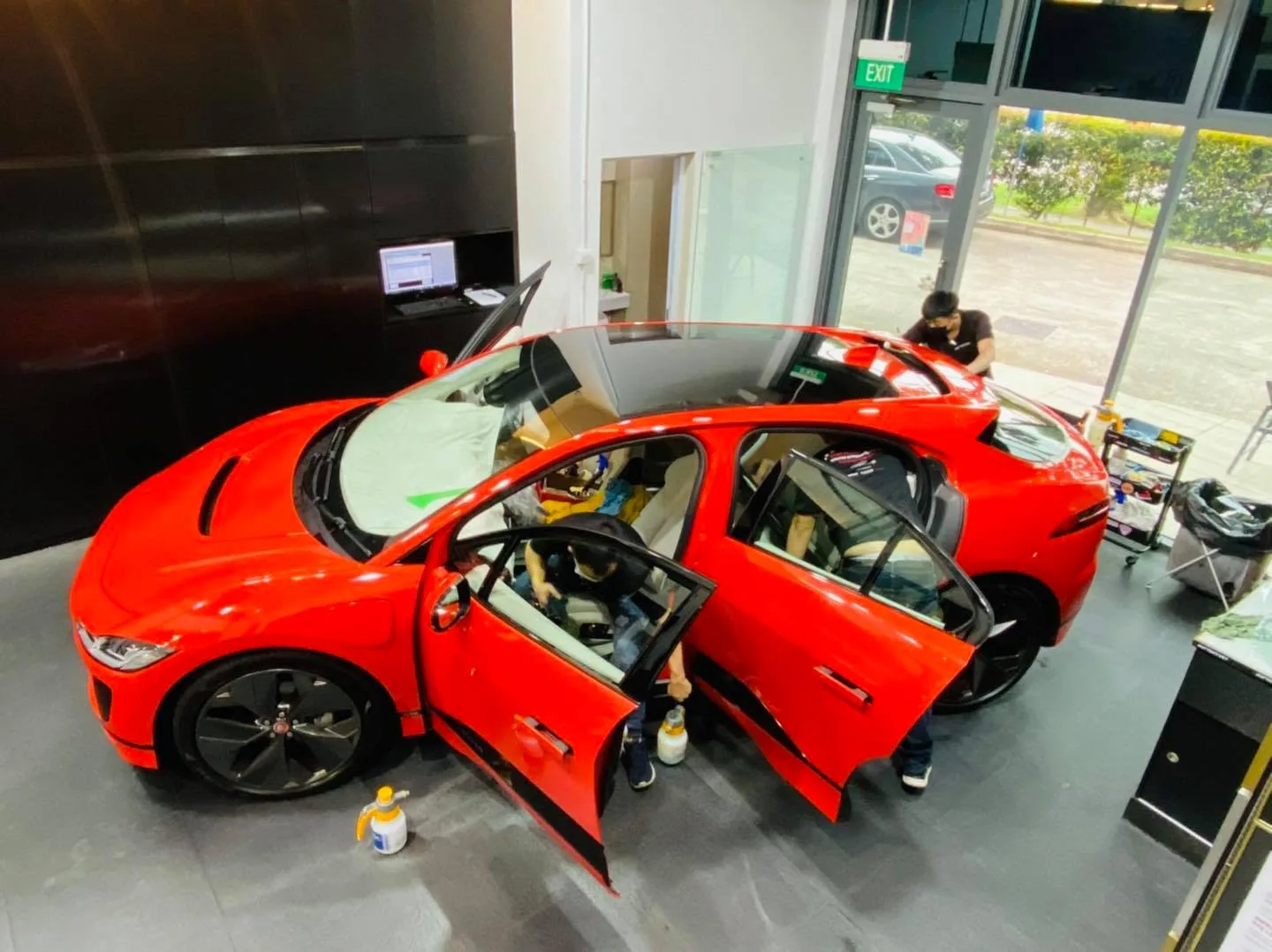 Overhead view of red Jaguar I-Pace window tinting at Infratint Singapore