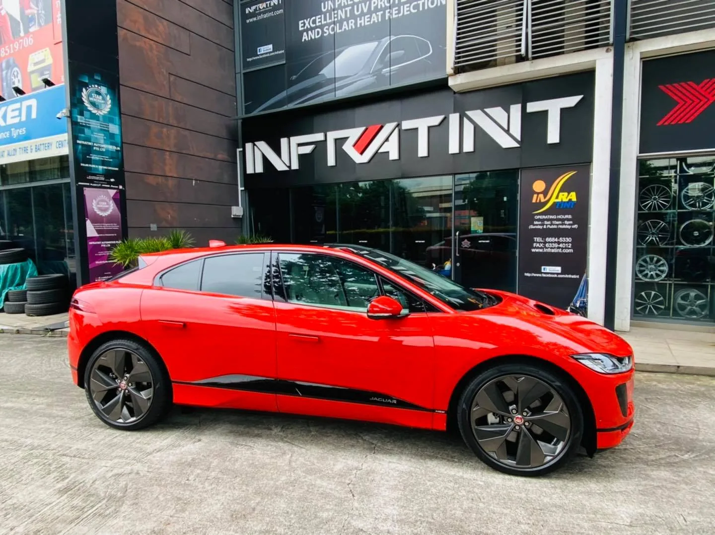 Red Jaguar I-Pace side profile outside Infratint Singapore