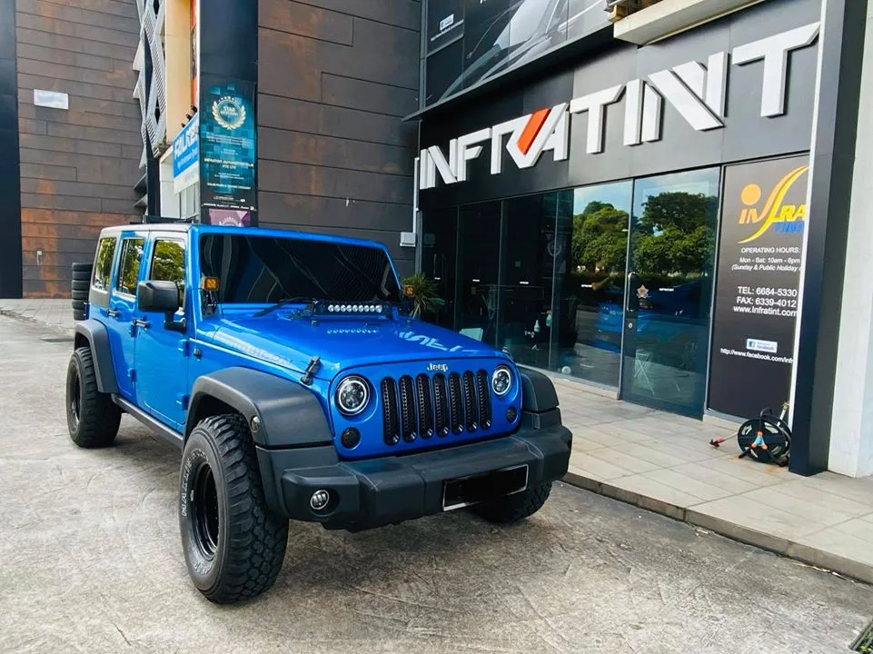Blue Jeep Wrangler Rubicon parked outside Infratint Singapore for window tinting
