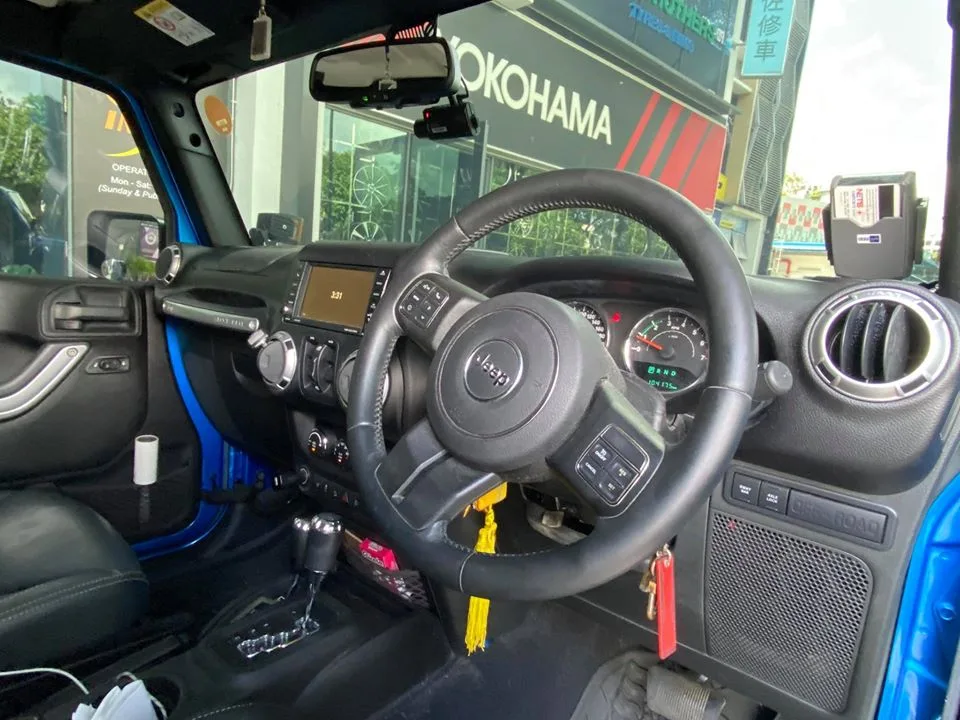 Interior steering wheel and dashboard of a Jeep Wrangler Rubicon tinted at Infratint Singapore
