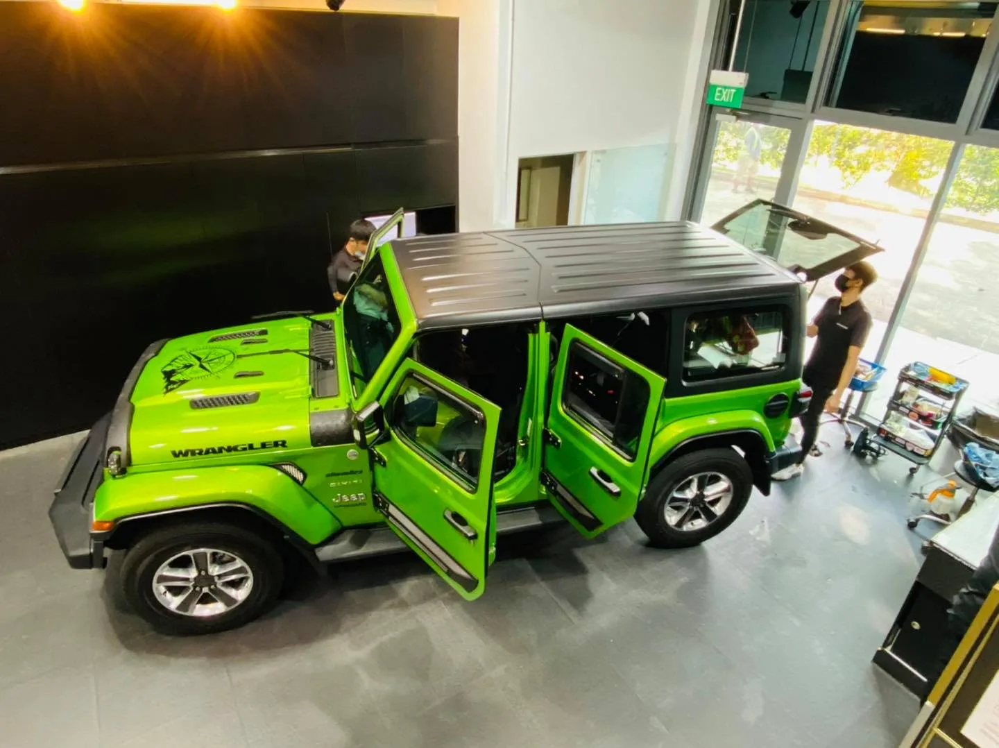 Overhead view of a green Jeep Wrangler during window film installation at Infratint Singapore
