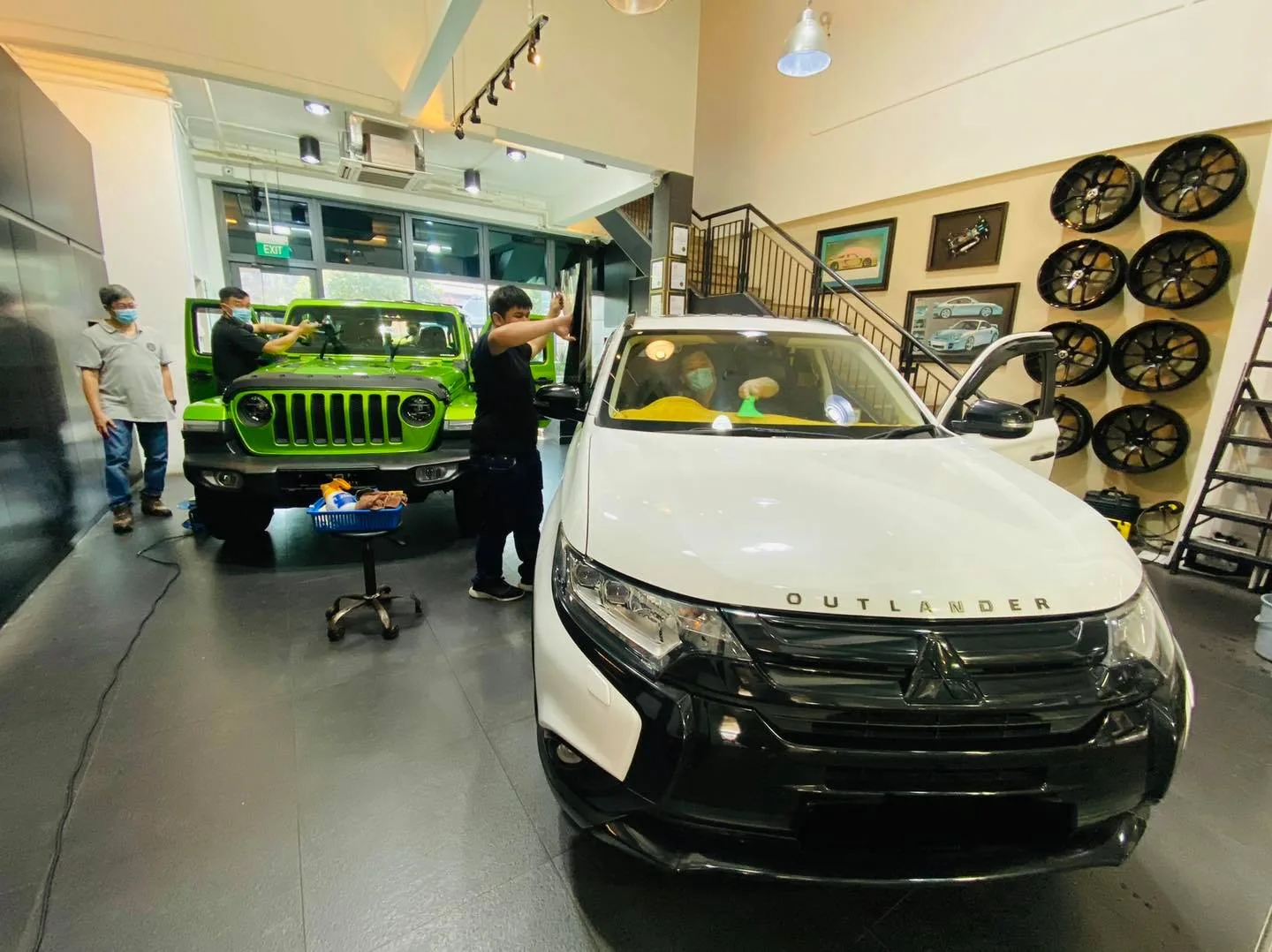 White Mitsubishi Outlander and green Jeep Wrangler at Infratint Singapore for tinting