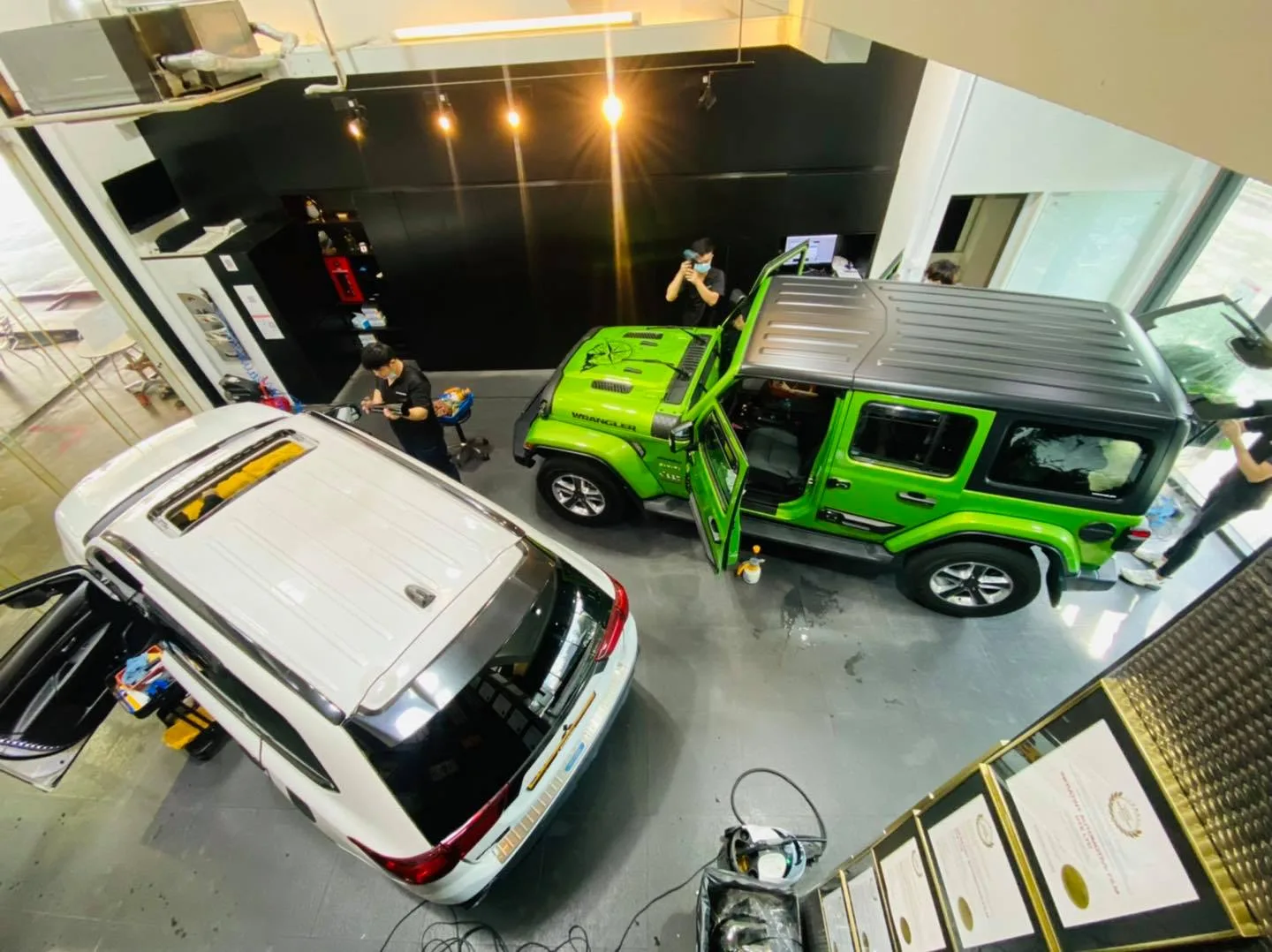 Overhead view of a white Mitsubishi Outlander and green Jeep Wrangler at Infratint Singapore