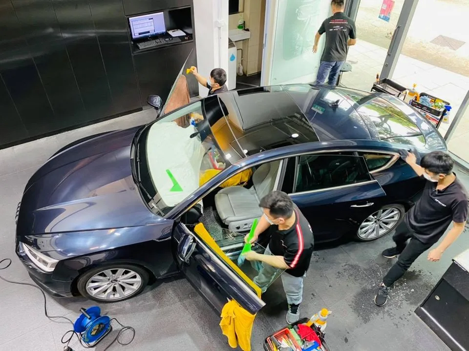 Overhead view of a dark blue Audi sedan being tinted at Infratint Singapore